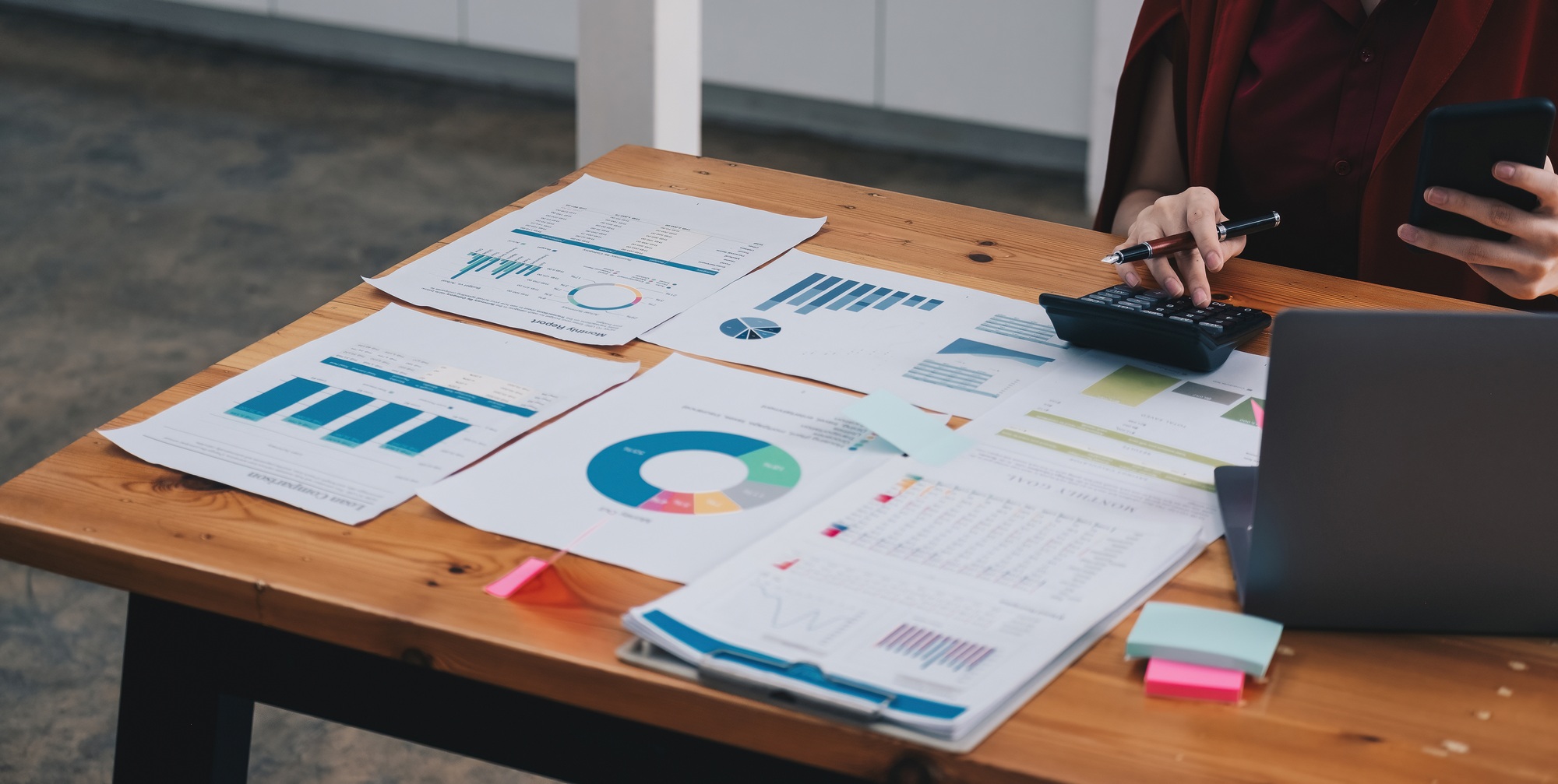 Close up Business woman analysis investment perform data document and calculating a valuation number